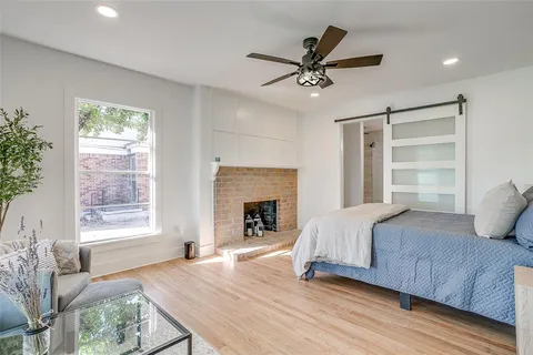 a bedroom with a bed and a ceiling fan