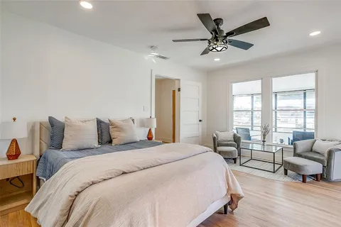 a spacious bedroom with a large bed and a chandelier