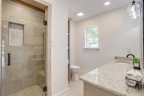 a bathroom with a granite countertop sink double and mirror