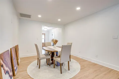 a dining room with furniture and wooden floor