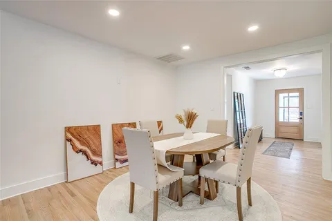 a living room with furniture a wooden floor and a chandelier