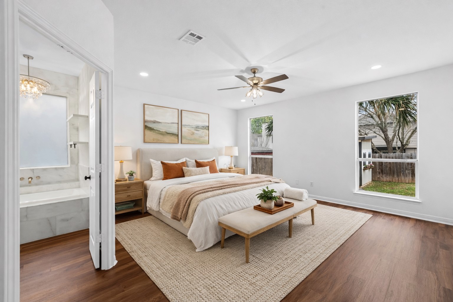 813 Caribou Ridge Trail Pflugerville, TX 78660 - Photo 21 of 39 Virtually Staged Spacious primary suite featuring warm luxury vinyl plank flooring, large windows with natural light, and a private spa-style ensuite bath.