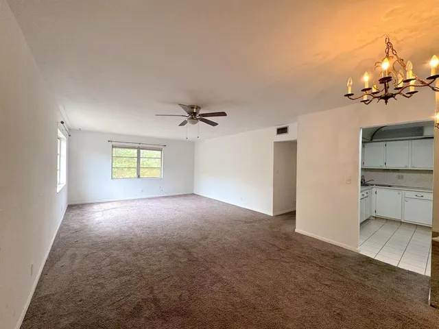 a view of a kitchen with a sink and a cabinet