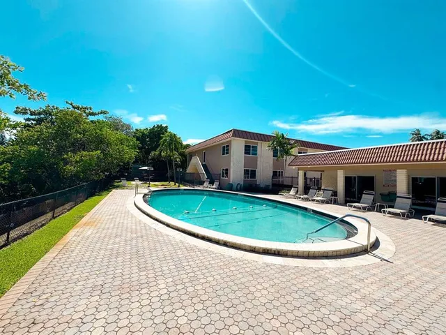 a swimming pool with outdoor seating and yard