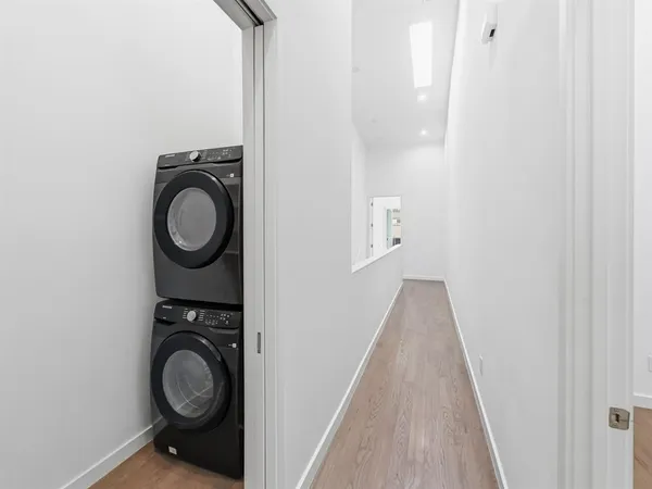 a view of a hallway with washer and dryer