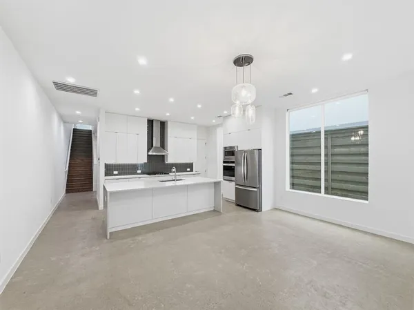 a kitchen with stainless steel appliances kitchen island sink stove and refrigerator
