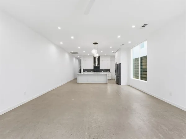 a view of a kitchen with a refrigerator and a window