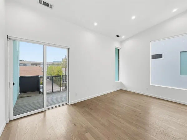 a view of an empty room with glass door
