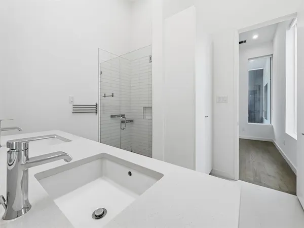 a bathroom with a tub sink and mirror