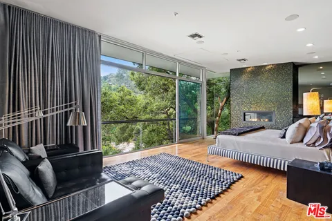 a view of a bedroom with a bed and glass door
