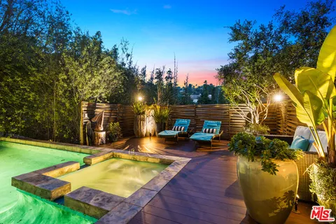 a house with potted plants in front of it