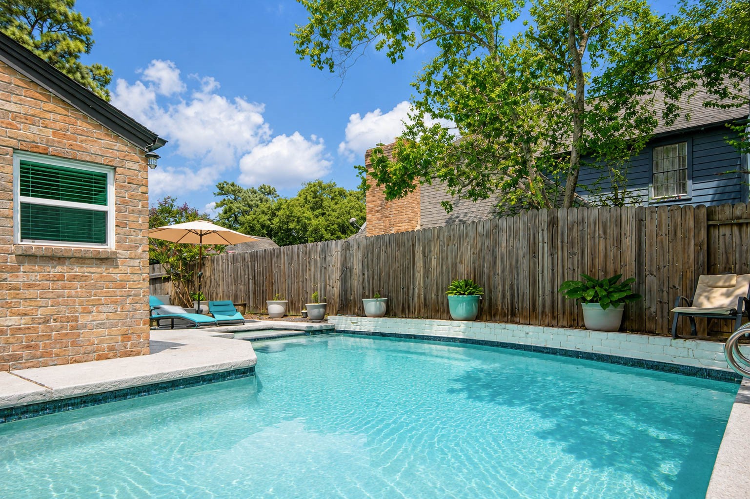630 South Fry Road Katy, TX 77450 - Photo 5 of 48 Relax in your private oasis featuring a sparkling pool, shaded seating, and a cozy brick fire pit, perfect for entertaining or unwinding.
