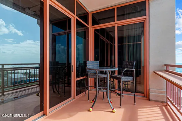 a view of porch with a table and chairs