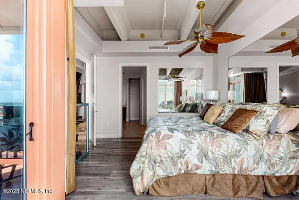 a large bedroom with a bed and a chandelier