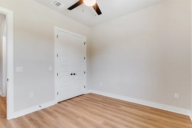 an empty room with a empty space and a ceiling fan