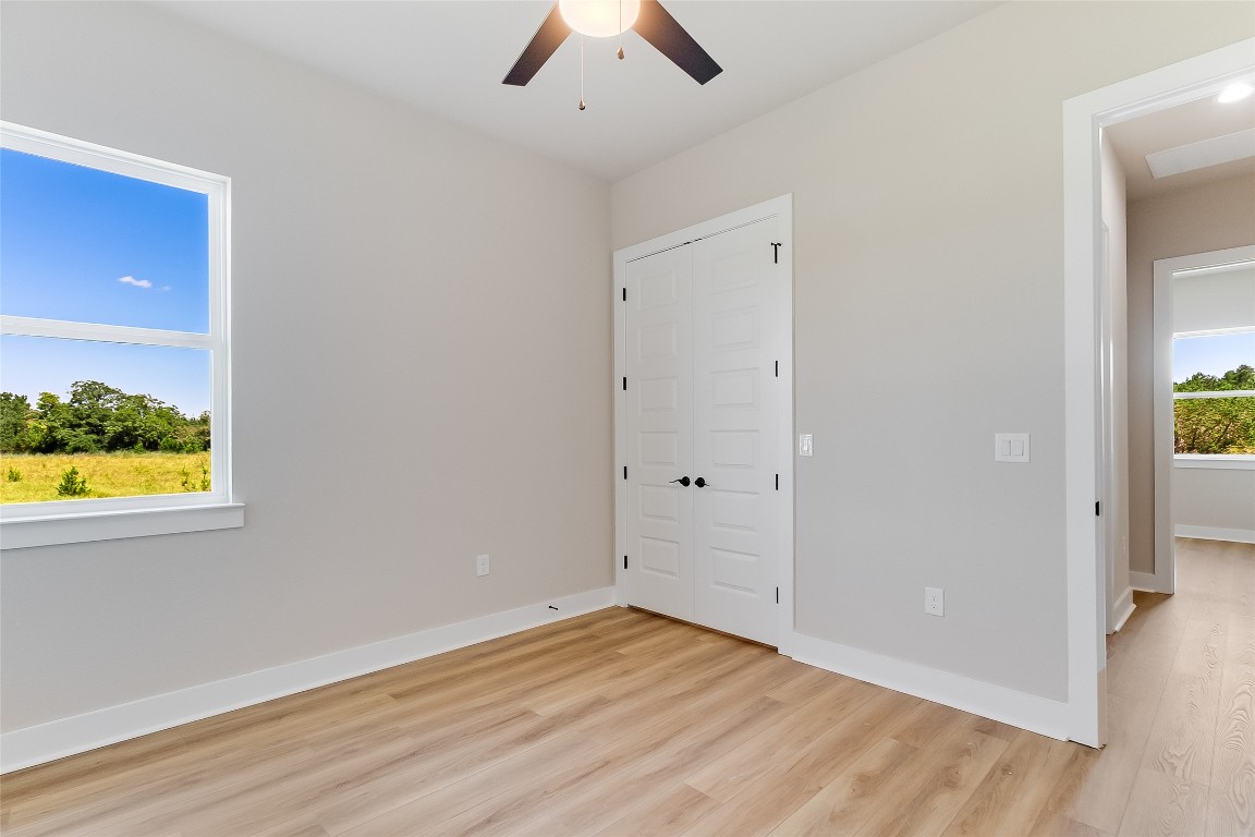 117 Rosebud Rnch Road Bertram, TX 78605 - Photo 25 of 29 a view of an empty room with wooden floor and a window