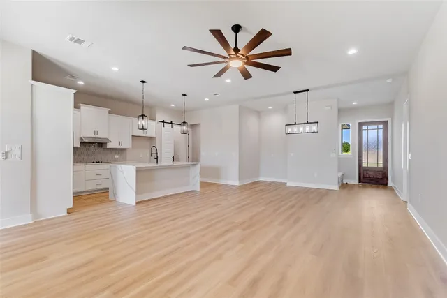 a view of kitchen with sink and refrigerator
