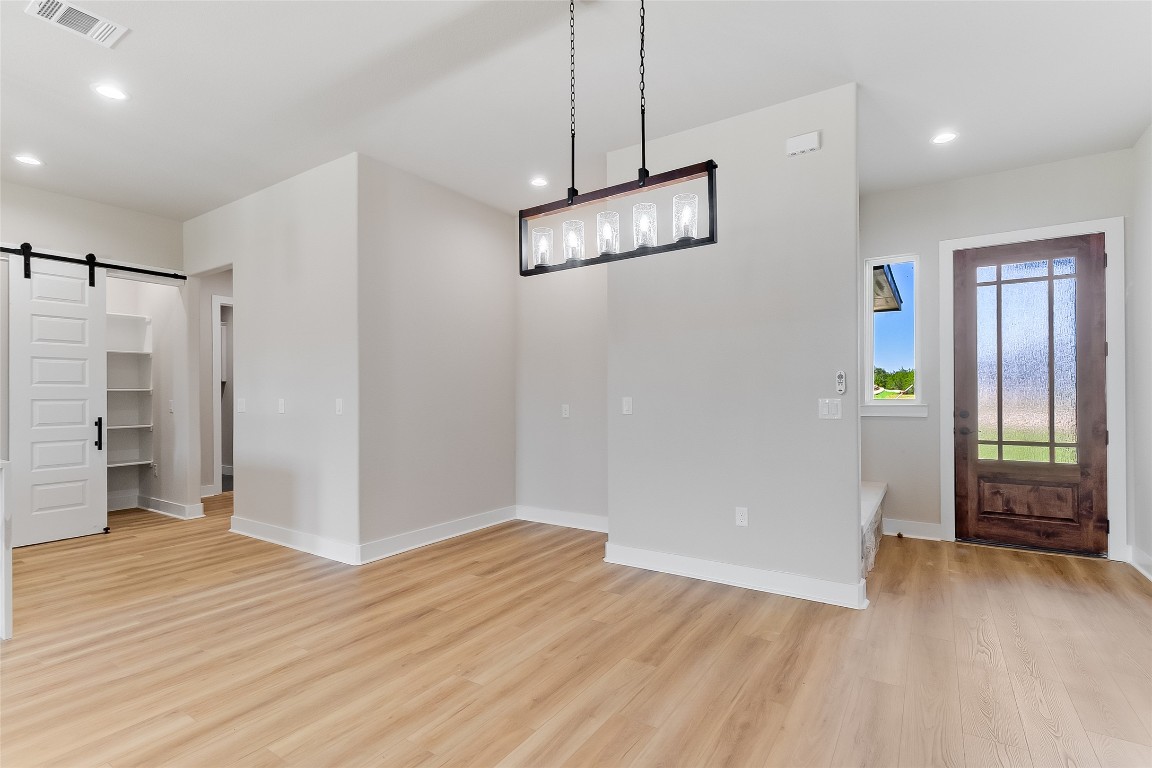 117 Rosebud Rnch Road Bertram, TX 78605 - Photo 8 of 29 a view of empty room with wooden floor and window