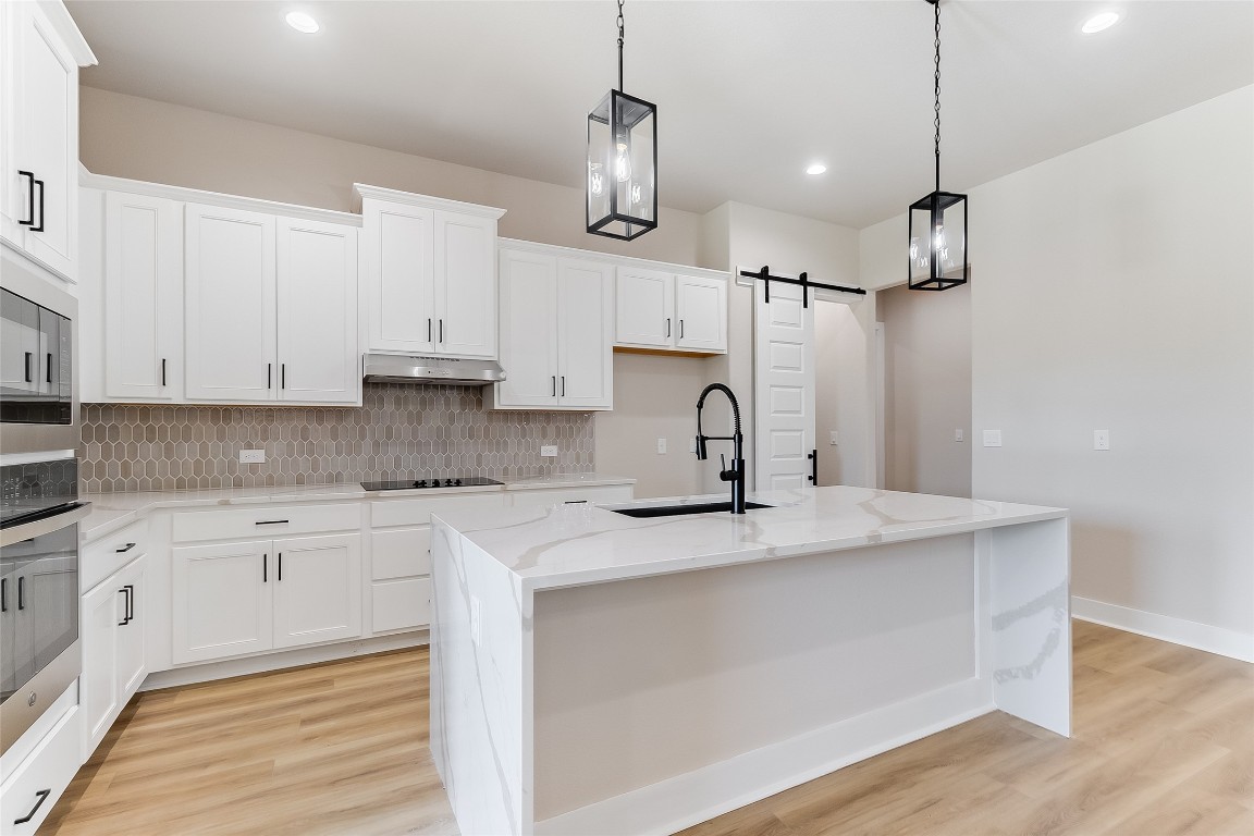 117 Rosebud Rnch Road Bertram, TX 78605 - Photo 10 of 29 a kitchen with stainless steel appliances granite countertop a sink a stove a refrigerator and white cabinets