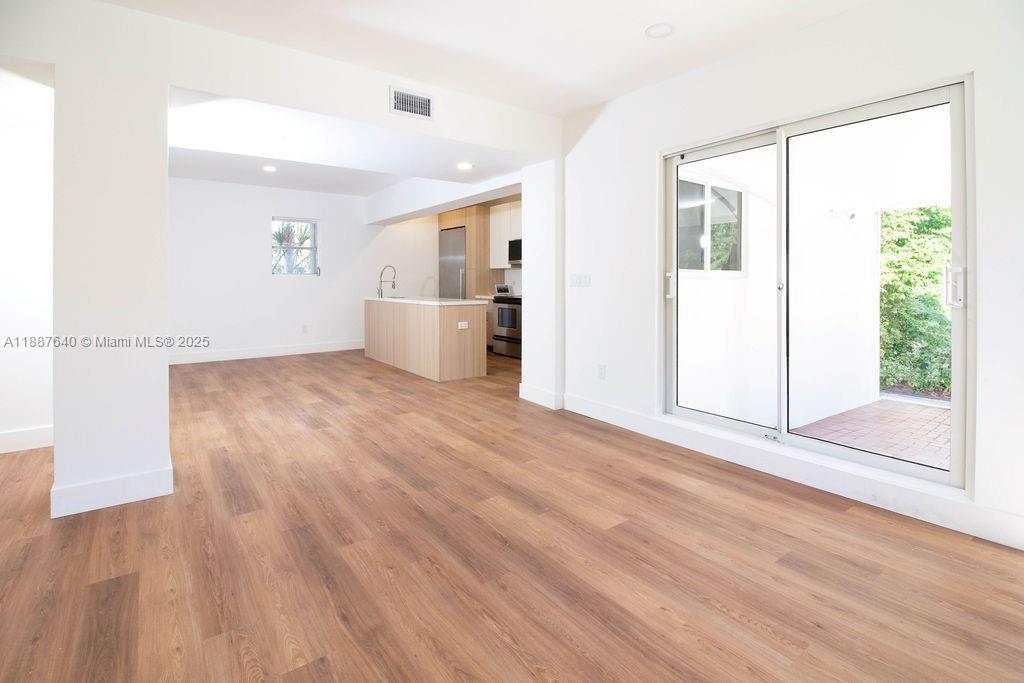 1255 Jackson Street Hollywood, FL 33019 - Photo 20 of 72 a view of a big room with wooden floor and windows