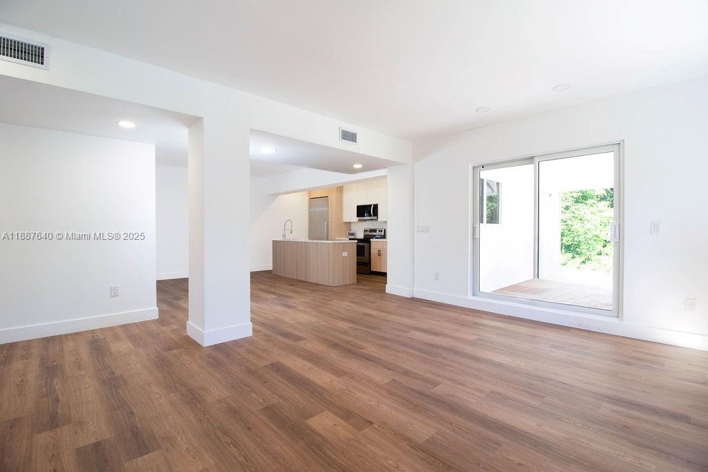1255 Jackson Street Hollywood, FL 33019 - Photo 23 of 72 a view of a big room with wooden floor and windows
