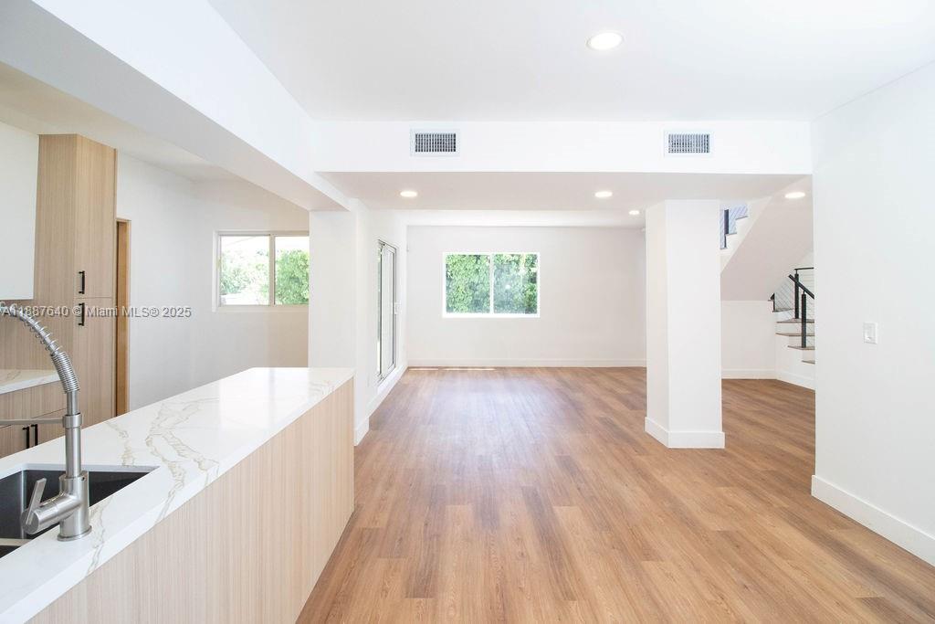 1255 Jackson Street Hollywood, FL 33019 - Photo 26 of 72 a view of a big room with wooden floor and windows