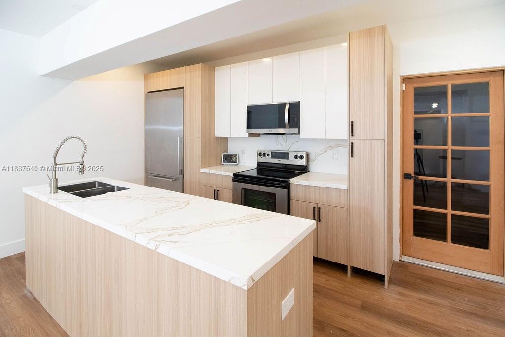 1255 Jackson Street Hollywood, FL 33019 - Photo 27 of 72 a kitchen with a sink a stove and a refrigerator