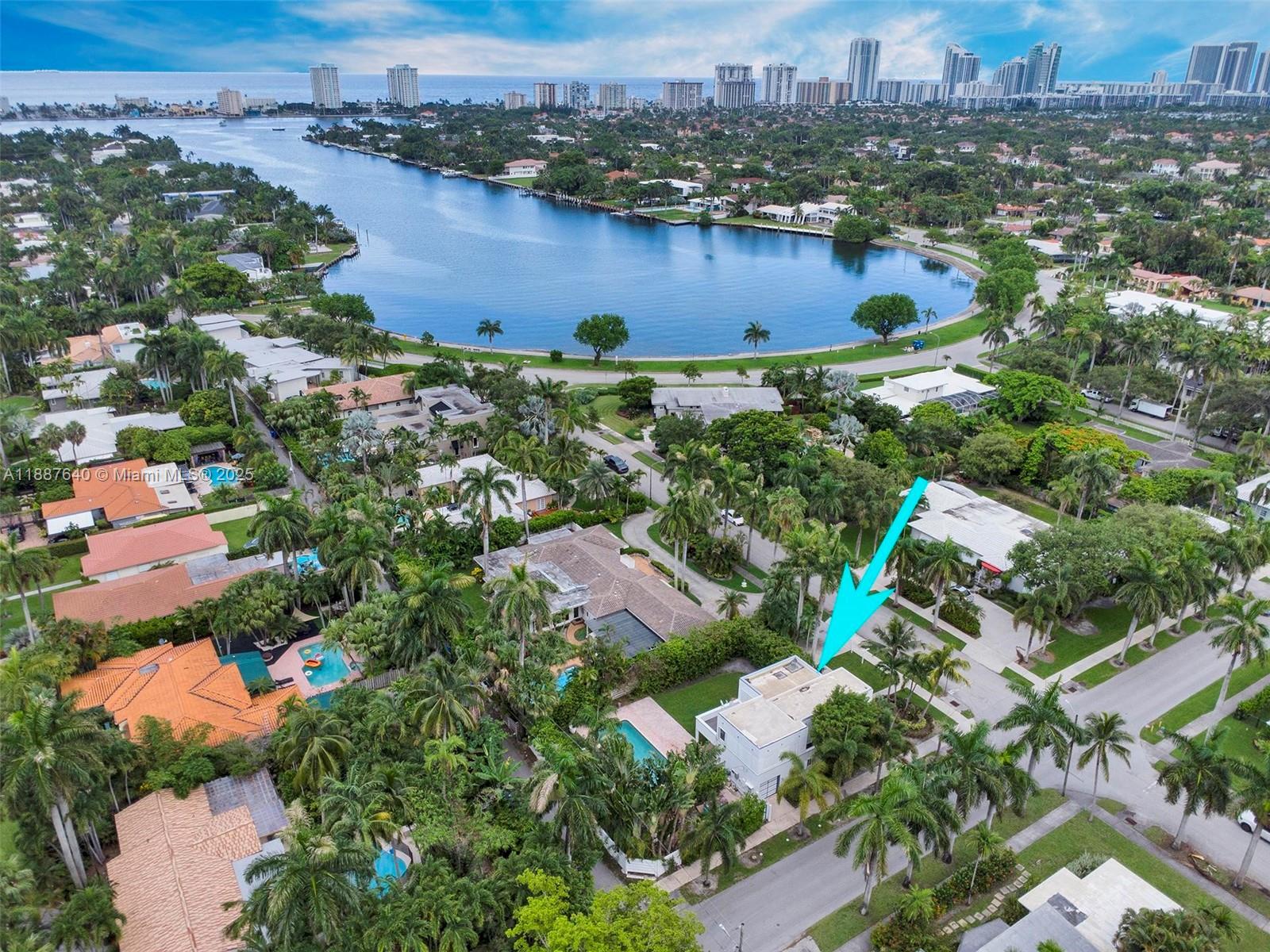 1255 Jackson Street Hollywood, FL 33019 - Photo 3 of 72 an aerial view of city and lake with trees all around