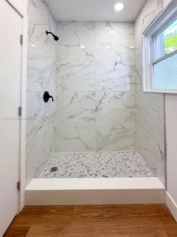 a view of room with window and wooden floor