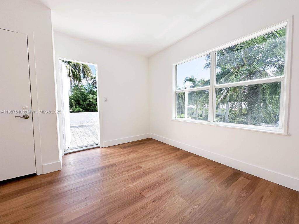 1255 Jackson Street Hollywood, FL 33019 - Photo 39 of 72 an empty room with wooden floor and windows