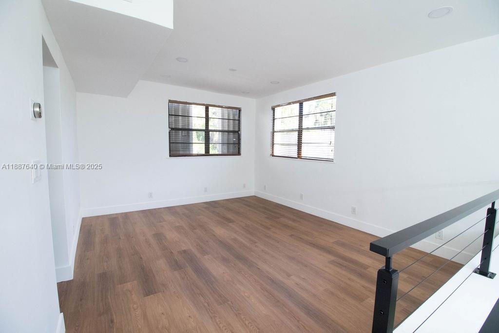 1255 Jackson Street Hollywood, FL 33019 - Photo 53 of 72 an empty room with wooden floor and windows