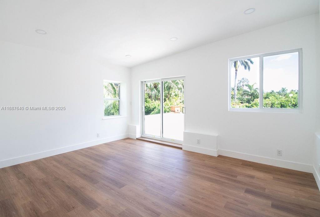 1255 Jackson Street Hollywood, FL 33019 - Photo 54 of 72 an empty room with wooden floor and windows