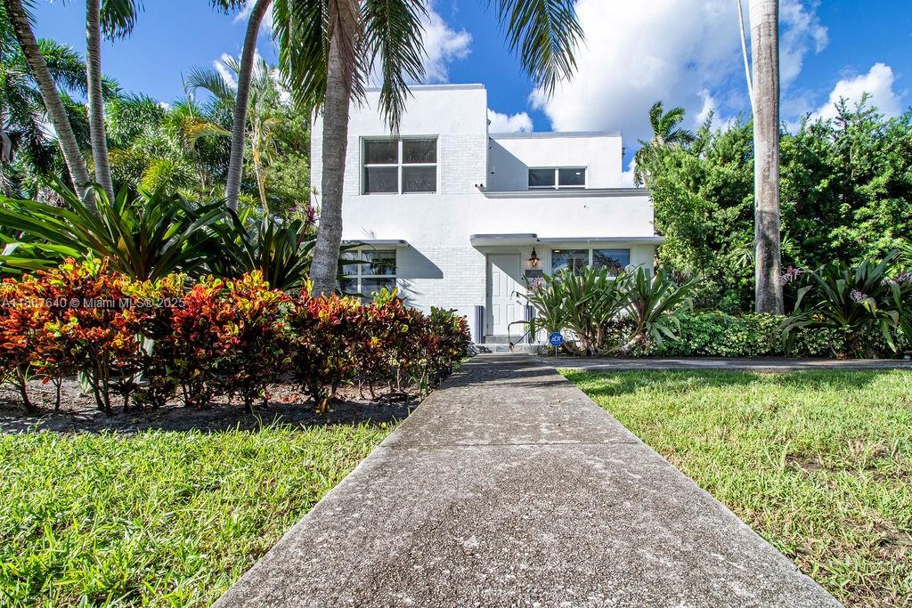 1255 Jackson Street Hollywood, FL 33019 - Photo 6 of 72 a front view of a house with a garden