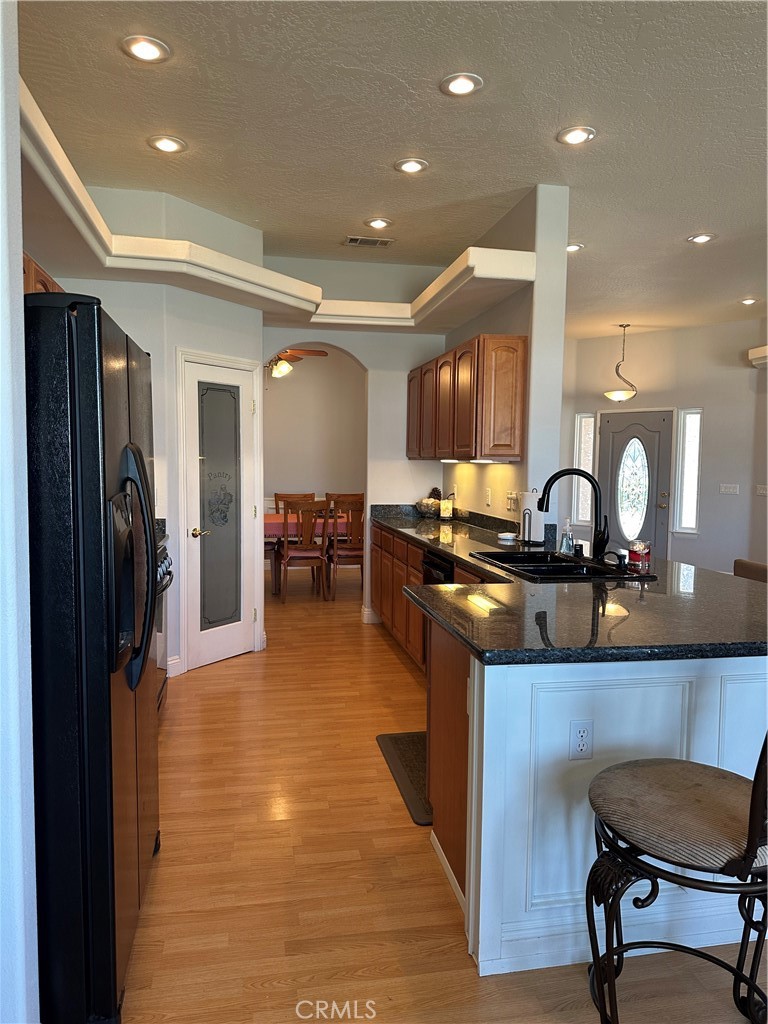 14108 Rivers Edge Road Helendale, CA 92342 - Photo 12 of 37 a kitchen with stainless steel appliances granite countertop a sink and a refrigerator