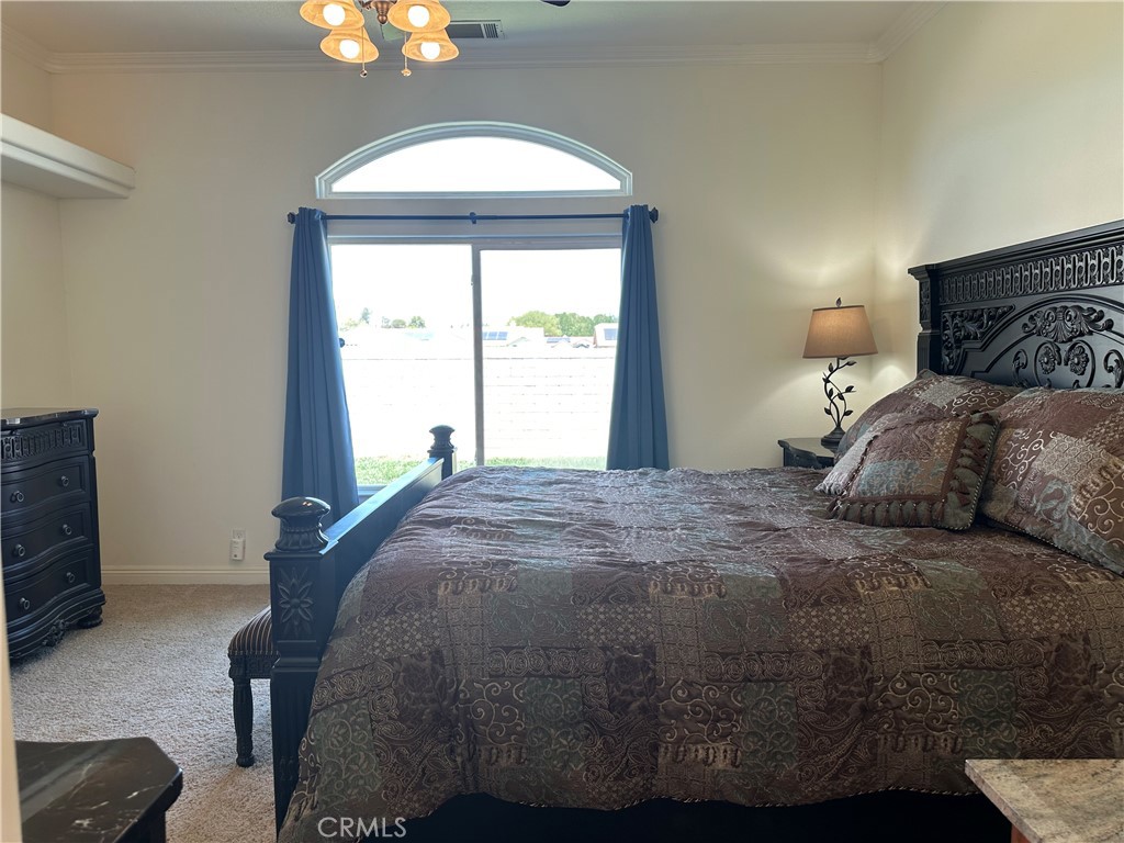 14108 Rivers Edge Road Helendale, CA 92342 - Photo 21 of 37 a bedroom with a bed and a window