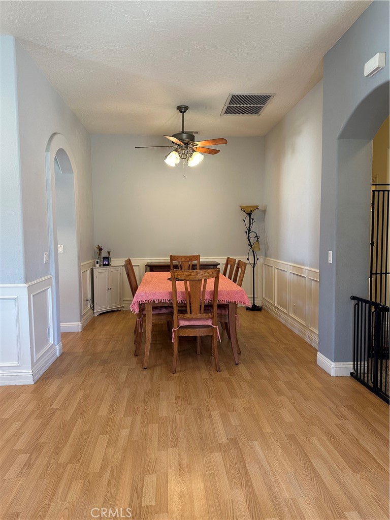 14108 Rivers Edge Road Helendale, CA 92342 - Photo 7 of 37 a dining room with furniture and a chandelier fan