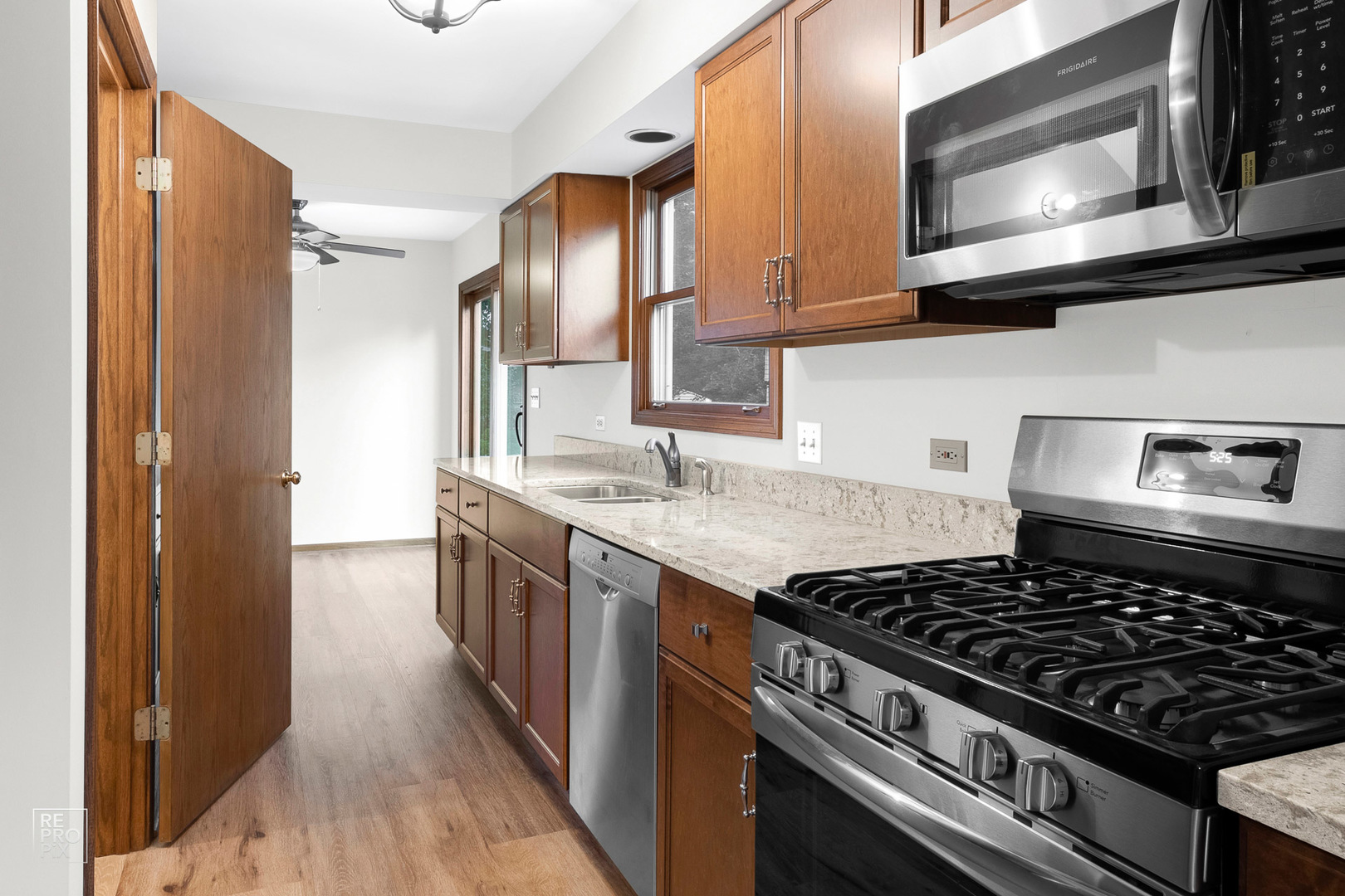 1205 East Camp McDonald Road Prospect Heights, IL 60070 - Photo 5 of 21 a kitchen with stainless steel appliances granite countertop a stove and a microwave