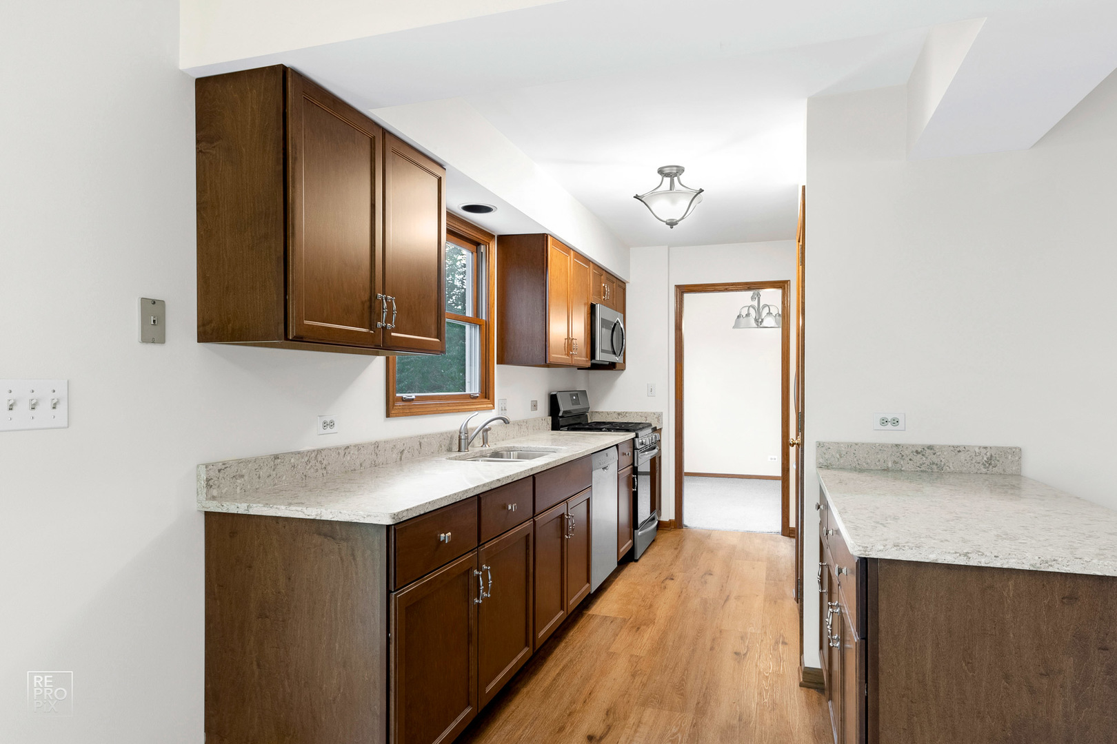 1205 East Camp McDonald Road Prospect Heights, IL 60070 - Photo 6 of 21 a kitchen with a sink cabinets and wooden floor