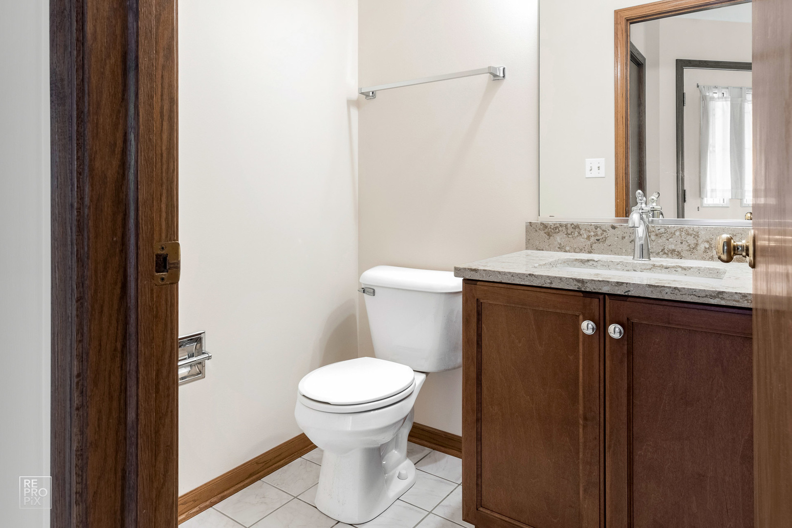 1205 East Camp McDonald Road Prospect Heights, IL 60070 - Photo 9 of 21 a bathroom with a granite countertop sink a toilet and a mirror