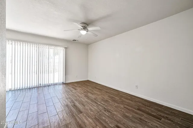 wooden floor in an empty room with a window
