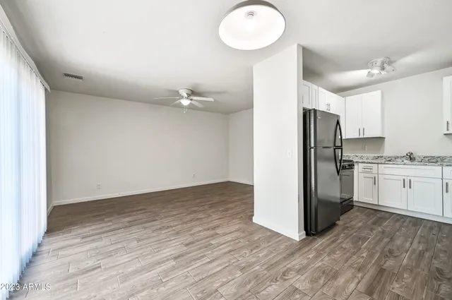a view of a kitchen with a refrigerator and microwave