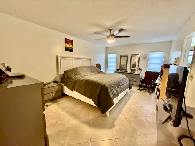 a bathroom with a sink a toilet a mirror and shower