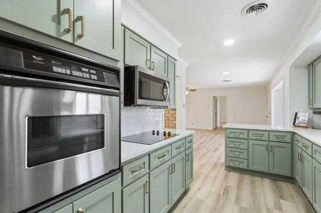 a kitchen with stainless steel appliances a sink stove and microwave