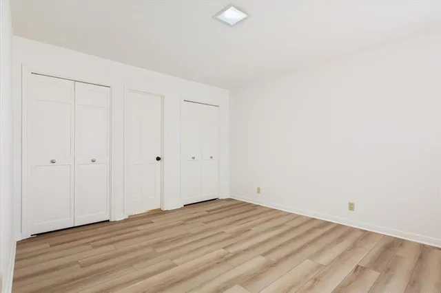 a view of a room with wooden floor