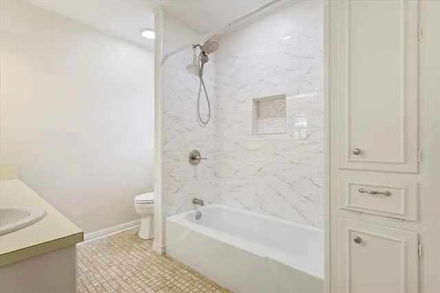 a bathroom with a bathtub a toilet and a shower