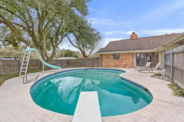 a swimming pool with outdoor seating and yard