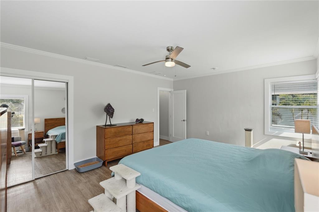 15424 2nd Street East Madeira Beach, FL 33708 - Photo 11 of 30 a bedroom with a bed and wooden floor