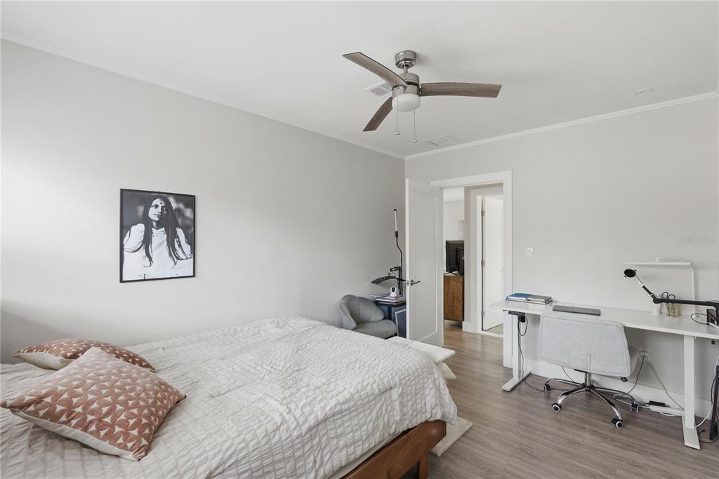 15424 2nd Street East Madeira Beach, FL 33708 - Photo 16 of 30 a bedroom with a bed and a chandelier