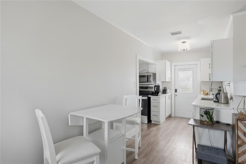 15424 2nd Street East Madeira Beach, FL 33708 - Photo 4 of 30 a workspace with furniture and kitchen view