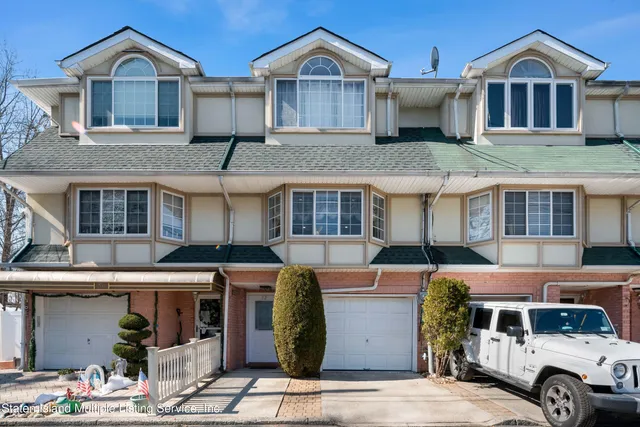 a front view of a residential apartment building with a yard